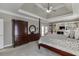 Main bedroom with tray ceilings, fireplace, built-in shelving and furniture throughout at 4171 Lantern Hill Dr, Dacula, GA 30019