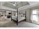 Spacious main bedroom features a fireplace, custom built-ins, and a four-poster bed at 4171 Lantern Hill Dr, Dacula, GA 30019