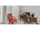 Cozy home office space with a desk, red chair, and double doors for privacy at 4171 Lantern Hill Dr, Dacula, GA 30019