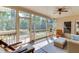 Relaxing screened porch with wood floors, ceiling fan, and view of the backyard at 4171 Lantern Hill Dr, Dacula, GA 30019