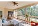 Comfortable screened porch with a ceiling fan and an outdoor seating area at 4171 Lantern Hill Dr, Dacula, GA 30019