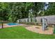 A backyard featuring a well-kept lawn, an in-ground pool with a slide, and a swing at 6889 Kingsboro Dr, Lithia Springs, GA 30122