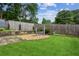 Backyard features a spacious lawn, a swing, and a meticulously maintained wooden fence at 6889 Kingsboro Dr, Lithia Springs, GA 30122
