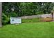Large backyard with lush green grass, a small shed, and mature trees at 6889 Kingsboro Dr, Lithia Springs, GA 30122