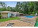A spacious backyard boasts an in-ground pool, gravel area, and green lawn at 6889 Kingsboro Dr, Lithia Springs, GA 30122