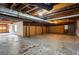 Unfinished basement with exposed pipes, concrete floor, and paneled walls at 6889 Kingsboro Dr, Lithia Springs, GA 30122