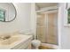 Well-lit bathroom with sliding glass door shower and large mirror at 6889 Kingsboro Dr, Lithia Springs, GA 30122