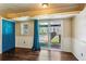 Bedroom with wood flooring, sliding glass door to the pool, and a blue closet door at 6889 Kingsboro Dr, Lithia Springs, GA 30122