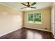 Bedroom with hardwood floors, a ceiling fan, and a window overlooking a backyard at 6889 Kingsboro Dr, Lithia Springs, GA 30122