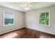 Bedroom with hardwood floors, a ceiling fan, and plenty of light from two windows at 6889 Kingsboro Dr, Lithia Springs, GA 30122