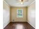 Bedroom featuring hardwood floors, a ceiling fan, and a window to let in natural light at 6889 Kingsboro Dr, Lithia Springs, GA 30122