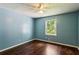 Bedroom with hardwood floors, lots of natural light, and neutral blue paint at 6889 Kingsboro Dr, Lithia Springs, GA 30122