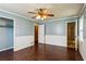 Bedroom with a ceiling fan and hardwood floors, with easy access to the bathroom at 6889 Kingsboro Dr, Lithia Springs, GA 30122