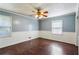 Bedroom featuring hardwood floors, wainscotting, and plenty of natural light at 6889 Kingsboro Dr, Lithia Springs, GA 30122