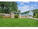 Side view of a well-manicured lawn and a charming split-level home at 6889 Kingsboro Dr, Lithia Springs, GA 30122