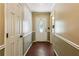 Hallway with tan walls and patterned floors leading to a white front door at 6889 Kingsboro Dr, Lithia Springs, GA 30122