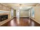 Bright living room with hardwood floors, a brick fireplace, and large windows at 6889 Kingsboro Dr, Lithia Springs, GA 30122
