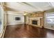 Spacious living room with hardwood floors, a brick fireplace, and a ceiling fan at 6889 Kingsboro Dr, Lithia Springs, GA 30122