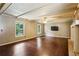 Spacious living room featuring hardwood floors, paneled walls, and a fireplace at 6889 Kingsboro Dr, Lithia Springs, GA 30122