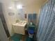 Bathroom with a sink, toilet, and decorative shower curtain at 8951 Stonebridge Blvd, Douglasville, GA 30134