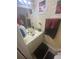 Cozy bathroom features a vanity with a sink, floral decor, and neutral tones at 8951 Stonebridge Blvd, Douglasville, GA 30134