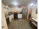 Functional kitchen with white cabinets, stainless steel appliances, and modern flooring at 8951 Stonebridge Blvd, Douglasville, GA 30134