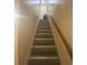 Carpeted stairway with wood handrail leading to the upper level of the home at 8951 Stonebridge Blvd, Douglasville, GA 30134