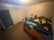 Bedroom featuring a bed, window, door, and various items scattered throughout the space at 8957 Stonebridge Blvd, Douglasville, GA 30134