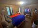 Bedroom with a bed, TV, window, and various items scattered throughout the space at 8957 Stonebridge Blvd, Douglasville, GA 30134