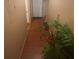 Hallway with wood laminate floors leading to various rooms, enhanced by plant decorations at 8957 Stonebridge Blvd, Douglasville, GA 30134
