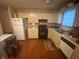 Functional kitchen featuring laminate floors, neutral cabinetry, and essential appliances at 8957 Stonebridge Blvd, Douglasville, GA 30134