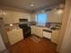 Efficient kitchen with laminate flooring, neutral cabinets, and standard appliances at 8957 Stonebridge Blvd, Douglasville, GA 30134