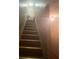 Carpeted staircase leading upwards with a handrail on the side and a light fixture overhead at 8957 Stonebridge Blvd, Douglasville, GA 30134