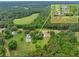 A beautiful aerial view of a home surrounded by lush greenery and a nearby meadow, creating a serene and private setting at 4444 Cannon Sw Rd, Loganville, GA 30052