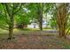 The spacious backyard features lush greenery and a chain-link fence at 4444 Cannon Sw Rd, Loganville, GA 30052