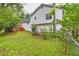 Exterior view of the home, shows the backyard with lush green grass at 4444 Cannon Sw Rd, Loganville, GA 30052