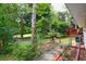 A fenced backyard with mature trees, a garden area, and a wooden deck at 4444 Cannon Sw Rd, Loganville, GA 30052