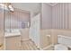 Compact bathroom features decorative wallpaper, a tiled floor, and a shower curtain at 4444 Cannon Sw Rd, Loganville, GA 30052