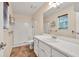 Bright bathroom featuring vanity and shower with tub at 4444 Cannon Sw Rd, Loganville, GA 30052