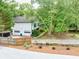 A charming home with a two-car garage, surrounded by lush greenery and a neatly fenced yard at 4444 Cannon Sw Rd, Loganville, GA 30052
