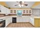 Well-lit kitchen with stainless steel appliances, white cabinetry, and vintage backsplash at 4444 Cannon Sw Rd, Loganville, GA 30052