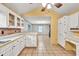 Open concept kitchen with views into the wallpapered dining area; bright and airy at 4444 Cannon Sw Rd, Loganville, GA 30052