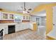 Traditional kitchen with brick backsplash, white cabinets, and views into the dining room at 4444 Cannon Sw Rd, Loganville, GA 30052