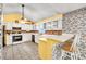 Bright kitchen with a breakfast bar, white cabinets, and brick backsplash at 4444 Cannon Sw Rd, Loganville, GA 30052