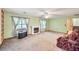 Bright living room featuring built-in shelving, a fireplace, and multiple windows at 4444 Cannon Sw Rd, Loganville, GA 30052