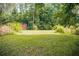 Level backyard featuring a small storage shed at 4565 Deerfield Dr, Cumming, GA 30028