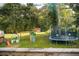 Backyard featuring mature trees, trampoline and swing set at 4565 Deerfield Dr, Cumming, GA 30028