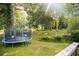 Backyard featuring mature trees and a trampoline at 4565 Deerfield Dr, Cumming, GA 30028