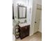 Modern bathroom featuring a vanity with storage, a decorative mirror, and a clean, organized layout at 4565 Deerfield Dr, Cumming, GA 30028