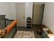 Bedroom featuring a crib, a rainbow rug, and neutral decor, creating a peaceful and cozy environment at 4565 Deerfield Dr, Cumming, GA 30028